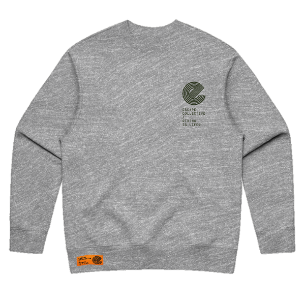 A heather gray crewneck sweatshirt shown from the back, featuring a dark green circular graphic and text on the upper right back, and an orange brand tag on the lower left hem.